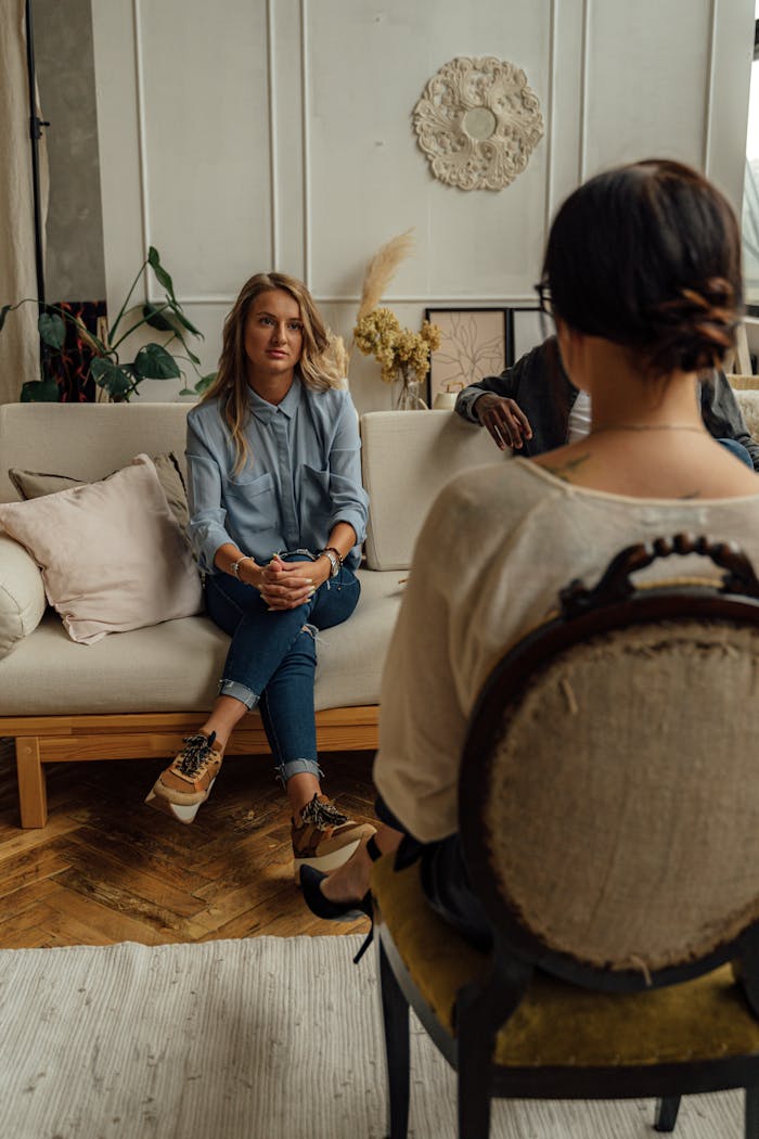 why-choose-us A therapist and client in discussion during a cozy indoor session highlighting mental health.