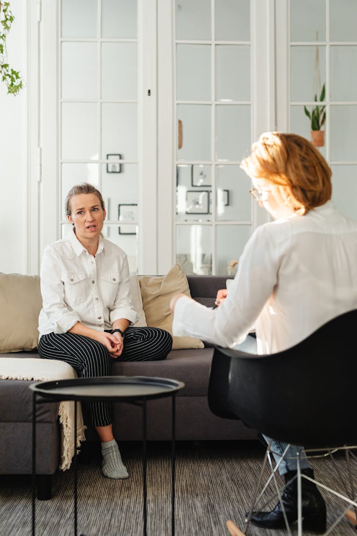services-03 A woman in therapy, engaged in discussion with a professional therapist.