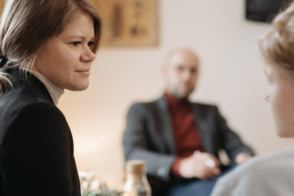 The Art of Drawing Readers In: Your attractive post title goes here A therapy session in progress with a therapist and two patients in focus.