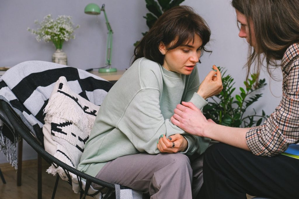 Crafting Captivating Headlines: Your awesome post title goes here Crop psychotherapist holding adult woman by arm while talking during psychological session in light house
